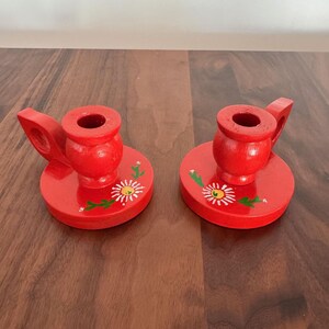 May include: A handmade wooden sign with the text "Welcome" in a playful font. The sign is painted white with a distressed finish, and features a small, decorative heart. Dimensions are approximately 12 inches wide and 6 inches high.