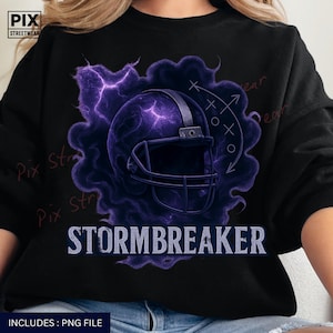 May include: Black sweatshirt featuring a purple football helmet design with lightning and the word "STORMBREAKER" in white. The design includes a play diagram and the text "INCLUDES: PNG FILE". The sweatshirt has the "PIX STREETWEAR" logo.