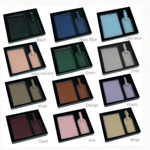 May include: A collection of twelve gift sets, each containing a rectangular passport holder and a matching luggage tag, presented in black boxes. The sets are available in black, navy blue, light blue, lotus root pink, green, gray, khaki, orange, purple, claret, pink, and beige.