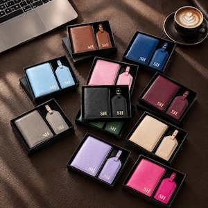 May include: A collection of gift sets, each containing a passport holder and a luggage tag in various colors including brown, blue, pink, black, burgundy, gray, green, beige, lavender, and magenta, all featuring the gold embossed initials SH.