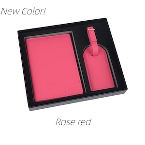 May include: A rose red passport holder and a matching luggage tag presented in a black gift box. The text New Color! appears at the top left and Rose red is printed at the bottom center. Both items feature a smooth, solid-colored finish.