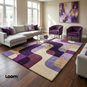 Puede incluir: Sal&oacute;n moderno con un sof&aacute; esquinero gris, dos sillones morados y una alfombra estampada en tonos morado, beige y marr&oacute;n. Una mesa de centro redonda de cristal y una pintura abstracta completan la decoraci&oacute;n.