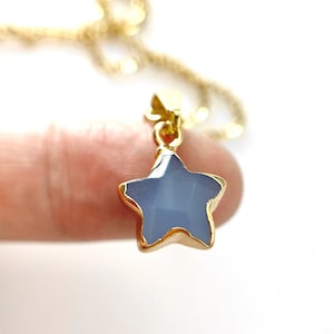 May include: A gold chain necklace with a light blue star-shaped pendant.