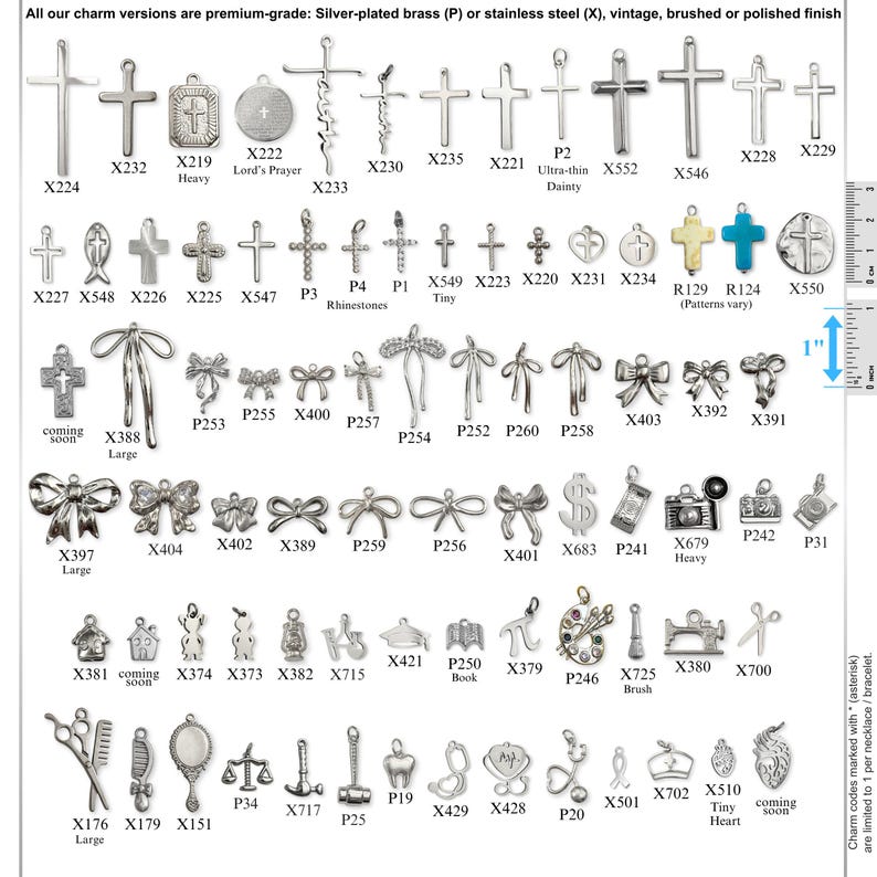 May include: A collection of silver-toned metal charms in various shapes including crosses, bows, tools, and symbols, each labeled with a code. A vertical ruler on the right side shows a 1-inch scale for size reference against the small metal pendants.