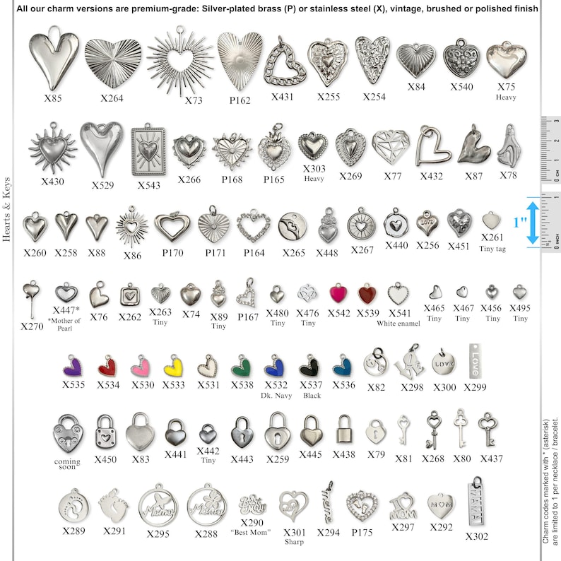 May include: A collection of silver-toned metal charms in various shapes including hearts, keys, and padlocks, arranged in rows with alphanumeric codes. A one-inch ruler is visible on the right side for scale. The charms feature diverse finishes.