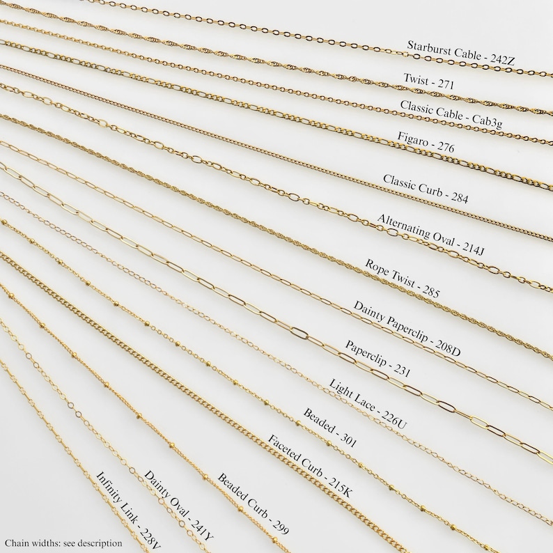 May include: A collection of gold-toned metal chains arranged diagonally, labeled with names and codes: Starburst Cable 242Z, Twist 271, Classic Cable Cab3g, Figaro 276, Classic Curb 284, Alternating Oval 214J, Rope Twist 285, Dainty Paperclip 208D, Paperclip 231, Light Lace 226U, Beaded 301, Faceted Curb 215K, Beaded Curb 299, Dainty Oval 241Y, and Infinity Link 228V.