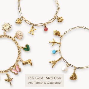 May include: Gold-colored charm bracelets with various pendants, including a heart, a letter "K", a seashell, a sun, a butterfly, and a sailboat. The bracelets are made of 18K gold with a steel core and are anti-tarnish and waterproof.