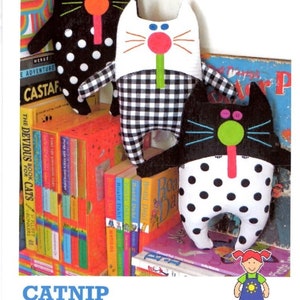 May include: Three handmade catnip cat toys. One black cat toy with white polka dots, one white cat toy with a black and white checkered pattern, and one black cat toy with white polka dots. The toys have green, pink, and orange accents. The text "CATNIP KITTIES" is at the bottom.