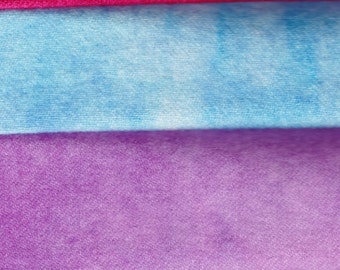 May include: Stack of six fabric swatches in different colors. The colors are pink, red, light blue, purple, green, and yellow.
