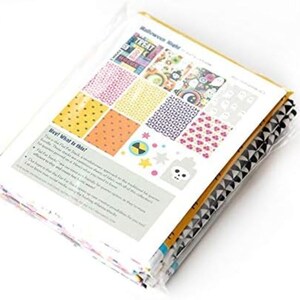 May include: A stack of fabric squares in a clear plastic package. The fabric squares feature various patterns, including polka dots, floral designs, and geometric shapes. The package includes a printed sheet with the text "Halloween Night".