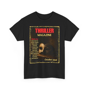 May include: A black short-sleeve t-shirt featuring a graphic print of a Thriller Magazine cover. The design includes a masquerade mask, the text Thriller Magazine, a list of authors, and the date October 2026, all framed in a yellow border.