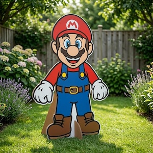 May include: A large, colorful cardboard cutout of the video game character Mario. Mario is wearing a red hat with a white "M", a red shirt, blue overalls, brown boots, and white gloves. The cutout is standing on a green lawn.