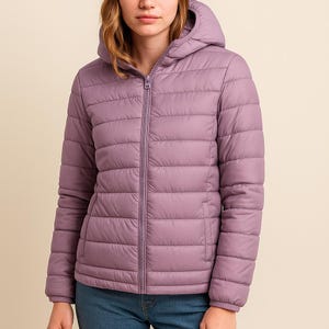 May include: A lavender puffer jacket with a hood and a full-length zipper. The jacket has horizontal quilted stitching and two side pockets. The sleeves are long and the jacket is made of a smooth, matte material.