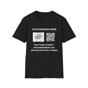 May include: Black t-shirt with white text and a logo. The text includes "YOUR BUSINESS NAME", "Scan Code to follow!", and a website address. A QR code and a logo are also present.