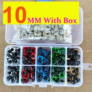 May include: A clear plastic organizer box filled with various colored craft eyes. The box contains black, red, blue, green, and tan eyes. The text "10 MM With Box" is displayed on a yellow background above the organizer.
