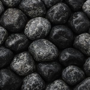May include: A close-up view of a collection of smooth, dark gray river rocks. The stones vary in size and shape, with some displaying lighter gray marbling patterns. The overall texture is glossy, suggesting they are wet or polished.