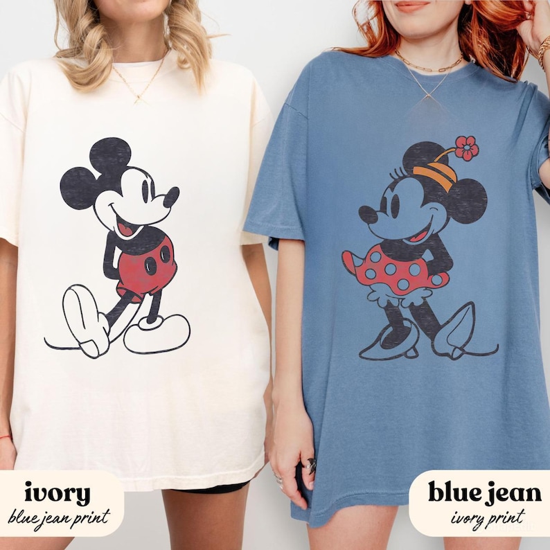 May include: Two oversized t-shirts, one ivory and one blue jean, each featuring a classic cartoon character print. The ivory shirt has a Mickey Mouse graphic, while the blue jean shirt displays Minnie Mouse. Text at the bottom reads "ivory blue jean print" and "blue jean ivory print."