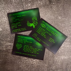 May include: A white ceramic mug with a black handle and the text "But First, Coffee" in a bold, black font. The mug is likely 11 ounces in size and sits on a white surface.