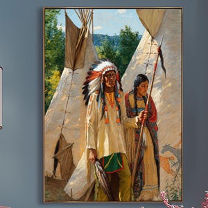 May include: A framed wall art print depicting two figures in traditional attire standing before teepees, displayed in a room with a pink velvet armchair, a matching round ottoman, a floor lamp, and a vase of pink cherry blossoms on a side table.