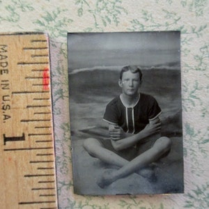 antique miniature gem tintype photo - 1800s, young man sitting cross legged at the beach, man in a swimsuit