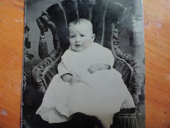 Tintype photo of young girl sitting in chair, late 1800s Tintype photo of young girl sitting in chair, late 1800s