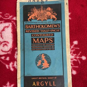 May include: Vintage Bartholomew's map of Argyll, Great Britain, sheet 47. The map features a blue and orange color scheme with text including "Hayes 47" and "Bartholomew's Revised Half-Inch Contoured Maps". The map is printed on paper.