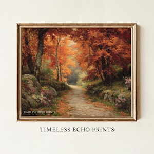 Può includere: Un dipinto paesaggistico incorniciato che raffigura un sentiero attraverso un bosco con fogliame autunnale dai colori arancione e rosso vivaci, terreno roccioso e fiori selvatici viola. Il testo "TIMELESS ECHO PRINTS" è visibile in basso a sinistra.