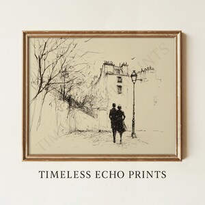 May include: Framed black and white sketch print featuring a couple walking on a cobblestone street, with buildings and a lamppost in the background. The print has a vintage aesthetic, with the text "TIMELESS ECHO PRINTS" at the bottom.