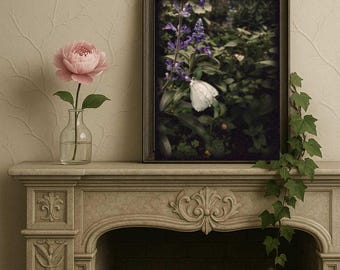 May include: A decorative fireplace mantel featuring a framed picture of a butterfly on a flower, a pink peony in a glass vase, and trailing ivy. The mantel is beige with ornate carvings and a brick interior.