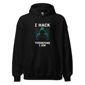 May include: Black hoodie featuring the text "I HACK THEREFORE I AM" and a teal and white graphic of a hooded figure using a laptop. The hoodie is made of a soft material and has a hood and front pocket.