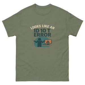 May include: Olive green t-shirt with the text "LOOKS LIKE AN ID 10 T ERROR" in a playful font. The design includes a stick figure and a computer screen with an alert symbol, perfect for tech enthusiasts.