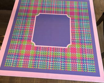 May include: A square mat featuring a vibrant plaid pattern in shades of hot pink, lime green, and blue. The design includes a solid purple square in the center with scalloped corners, all framed by a thick, solid light pink border edge.