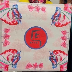 May include: A square scarf with a watercolor design featuring four horse heads in red, blue, and pink. The center has a red circle with a black Japanese character. Pink floral accents and a light background complete the design.