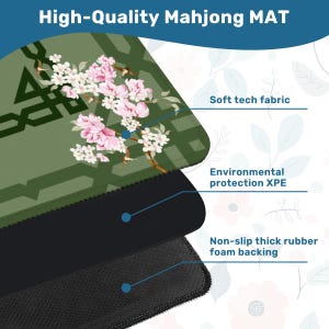 May include: High-Quality Mahjong MAT with a floral design. The mat features a green background with a pattern and a branch of pink flowers. The mat has a soft tech fabric, environmental protection XPE, and non-slip thick rubber foam backing.