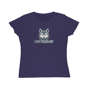 May include: A navy blue t-shirt featuring a wolf illustration with the text "I BE FEARLESS" in white. The wolf has gray and white fur with orange eyes. The shirt is made of a soft material.