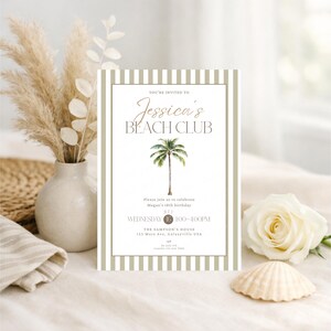 May include: An invitation card for "Jessica's Beach Club" featuring a palm tree illustration. The card has a striped border in neutral tones. A white rose, seashell, and vase of dried flowers are arranged in the background, creating a beach theme.