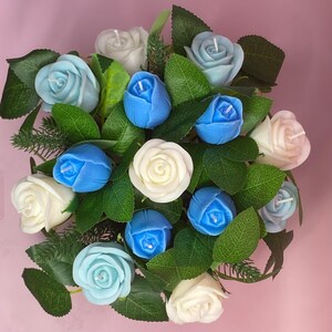 May include: A white ceramic mug with a black handle and the text "But First, Coffee" in a black, bold font. The mug is on a white surface.