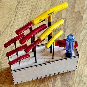 May include: A set of Bondhus T-handle hex wrenches in a wooden organizer. The wrenches have red and yellow handles, with sizes labeled in inches. The organizer is made of light-colored wood and has labeled slots for each wrench.