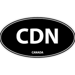 May include: An oval-shaped sticker with a black background and a thin white border. The letters CDN are printed in large, bold white font in the centre. Below the letters, the word CANADA is printed in a smaller, simple white sans-serif font.