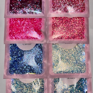 May include: A set of three ceramic mugs with a speckled, matte finish. The mugs are in shades of cream, light gray, and dark gray. Each mug has a simple, modern design and a rounded handle.