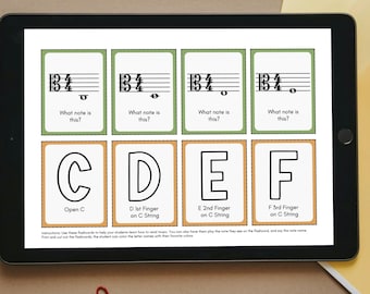 May include: A tablet displays viola flashcards with musical notes and lettered finger positions. The image includes pencils, scissors, paper, glue, and the text "Print Cut Learn."