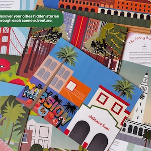 May include: A collection of colorful city-themed art prints. The prints feature illustrations of buildings, palm trees, and text, including "Mission St" and "Deliciosos Tacos." The text "Discover your cities hidden stories through each scene adventure" is also visible.