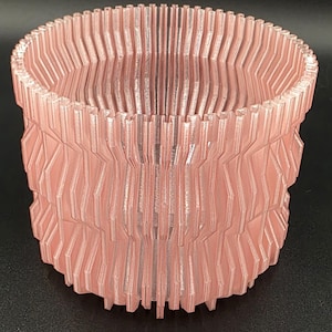 May include: A white ceramic mug with a black handle and the text "But First, Coffee" in a black, handwritten-style font. The mug is on a white surface.