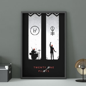 May include: Framed Twenty One Pilots poster. The black and white artwork features band symbols, silhouettes of a drummer and a person with their arm raised, and the band's name in white text.