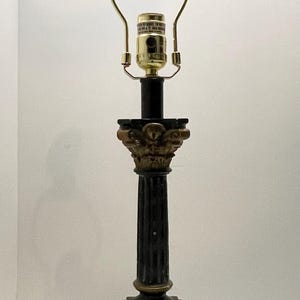 May include: A white ceramic mug with a black handle and the text "But First, Coffee" in a bold, black font. The mug is set against a blurred background, highlighting its clean design.