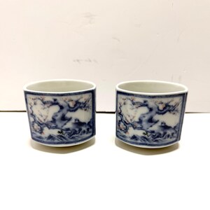 May include: A set of three ceramic mugs with a speckled, matte finish. The mugs are in shades of cream, light gray, and dark gray. Each mug has a simple, minimalist design and a rounded handle.
