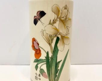 Vaso cilindrico vintage in ceramica artistica firmata McCoy, con motivo floreale e farfalle di ispirazione asiatica.