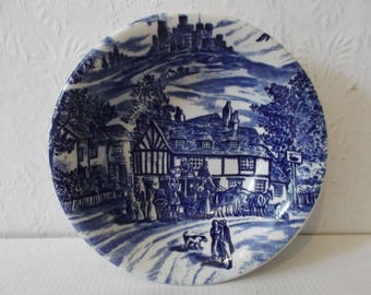 May include: Blue and white ceramic saucer with a detailed scene of a village with a castle in the background. The scene includes a building with a sign that reads "The Swan Inn".