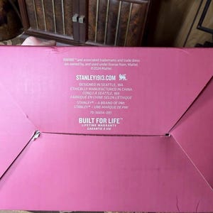May include: A pink cardboard box with white text. The text includes "BARBIE" and "STANLEY1913.COM". The box also states "BUILT FOR LIFE" and "LIFETIME WARRANTY".