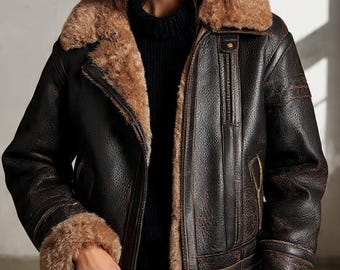May include: A brown leather aviator jacket with a shearling collar and cuffs. The jacket has a zipper closure and a distressed finish. A brown handbag is held in the hand.